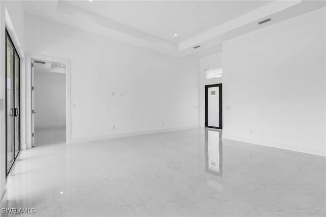 unfurnished room featuring a tray ceiling