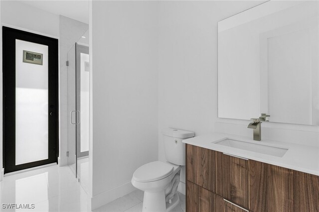 bathroom with tile patterned floors, vanity, and toilet