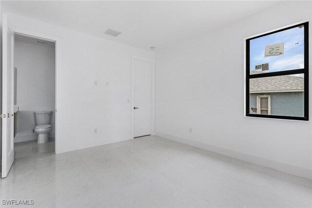 unfurnished bedroom featuring ensuite bathroom