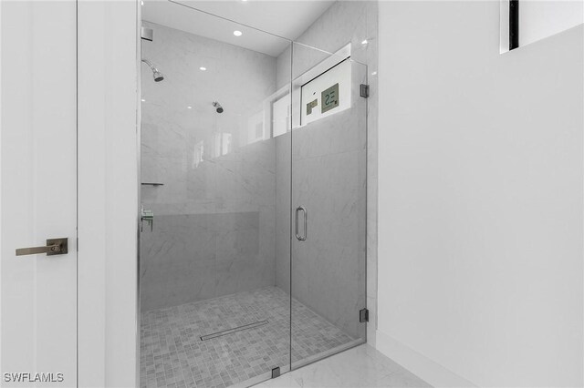 bathroom with a shower with shower door