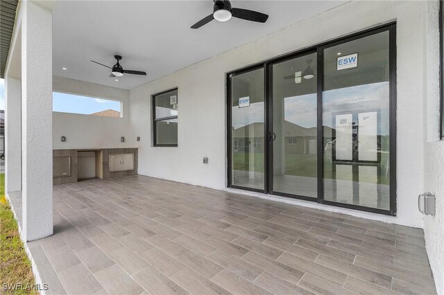 view of patio / terrace with ceiling fan and an outdoor kitchen