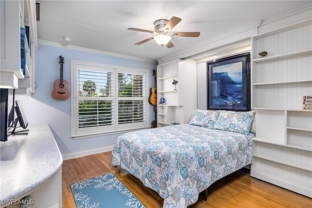 bedroom with hardwood / wood-style flooring, ceiling fan, and crown molding