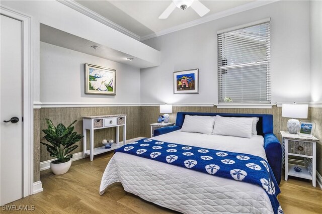 bedroom featuring wood-type flooring, ceiling fan, and crown molding