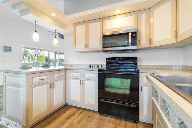 kitchen featuring hanging light fixtures, black range with electric cooktop, light wood-type flooring, and kitchen peninsula