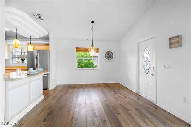 foyer featuring lofted ceiling and dark hardwood / wood-style flooring