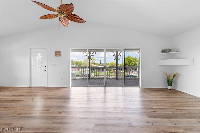 unfurnished living room with ceiling fan, light hardwood / wood-style floors, and vaulted ceiling