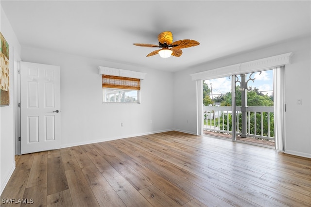 spare room with light wood-type flooring and ceiling fan