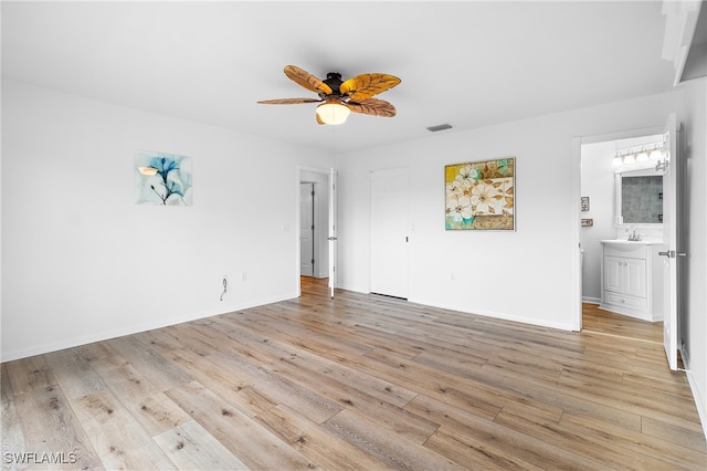 interior space with light wood-type flooring and ceiling fan