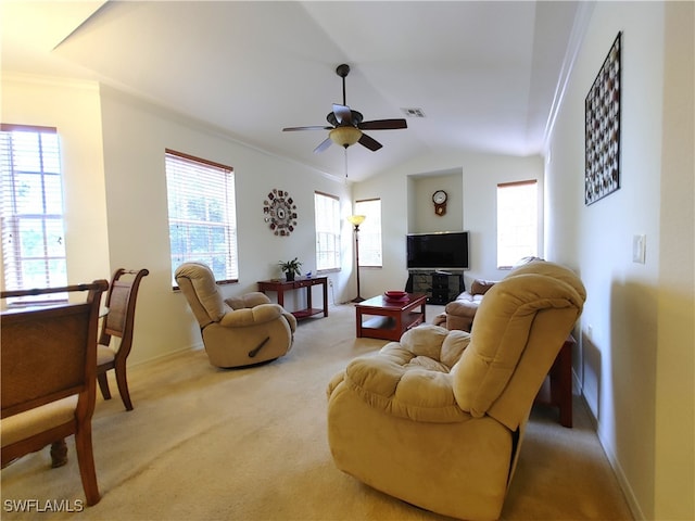 carpeted living room featuring crown molding, lofted ceiling, and ceiling fan