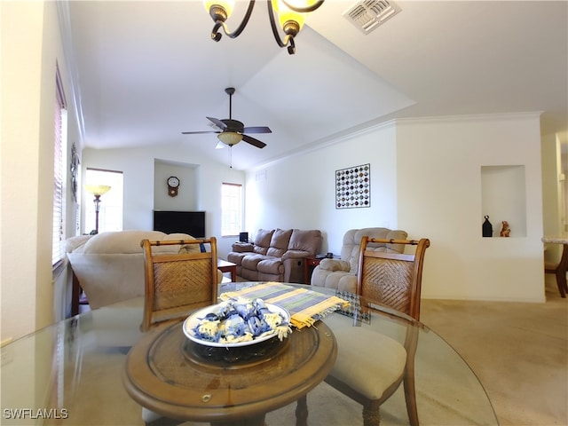 dining area with ceiling fan with notable chandelier, carpet, lofted ceiling, and crown molding