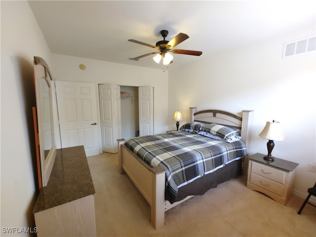 carpeted bedroom featuring ceiling fan and a closet