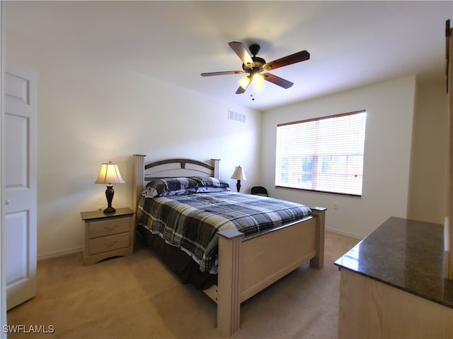 bedroom with light carpet and ceiling fan