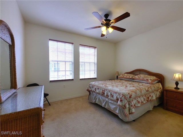 bedroom featuring light carpet and ceiling fan