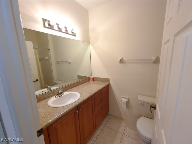 bathroom featuring tile patterned floors, walk in shower, vanity, and toilet