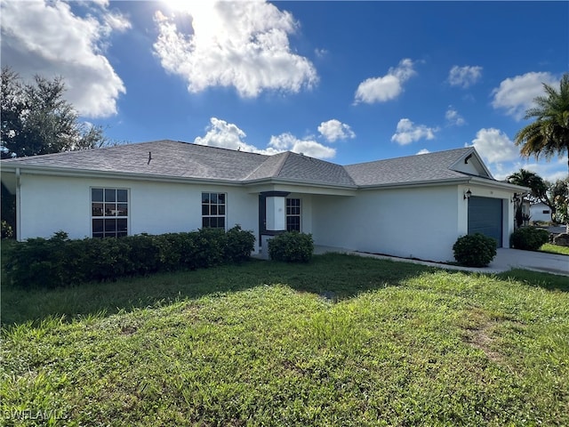 ranch-style house featuring a garage, stucco siding, concrete driveway, and a front yard