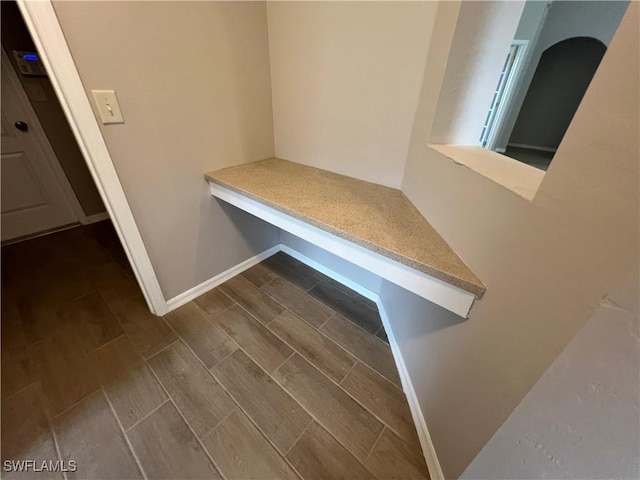 mudroom with wood finish floors and baseboards