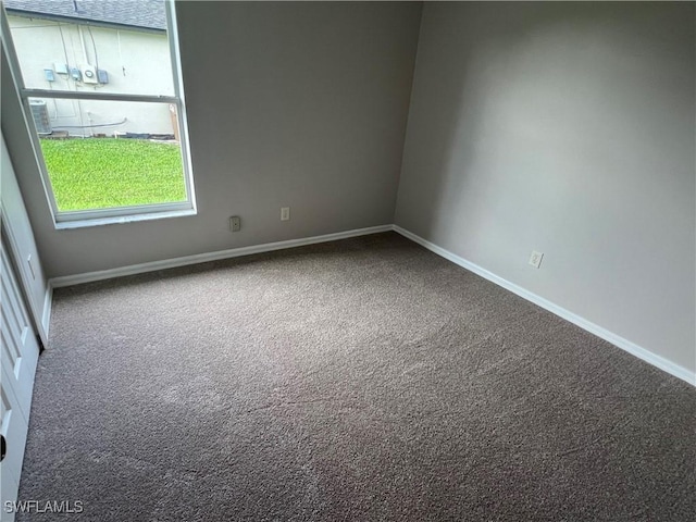 carpeted spare room with baseboards