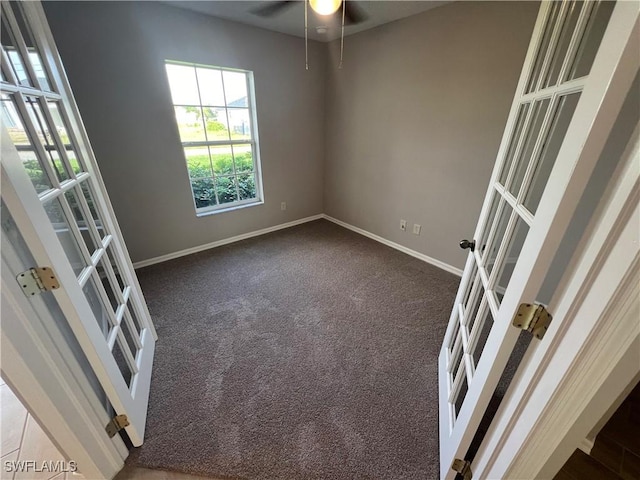 carpeted empty room with ceiling fan and french doors