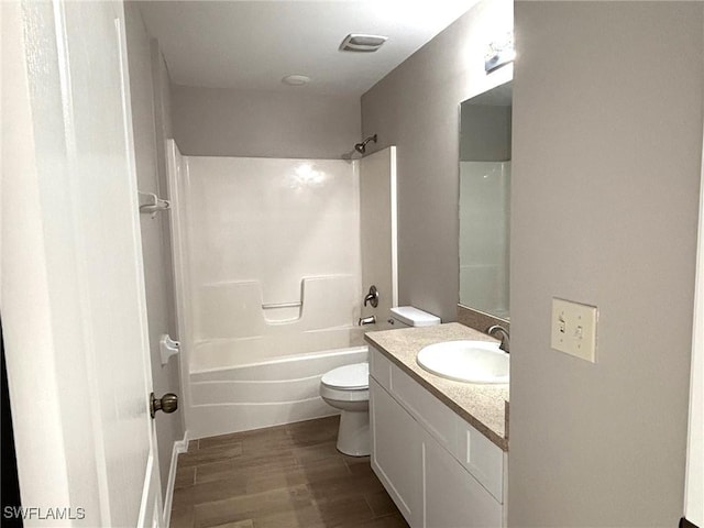 full bathroom with bathing tub / shower combination, visible vents, toilet, vanity, and wood finished floors