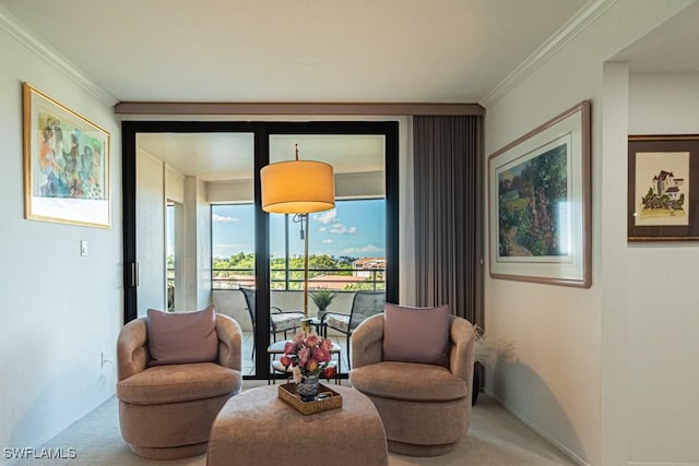 sitting room featuring ornamental molding and carpet floors