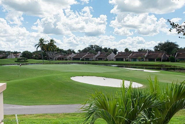 view of community featuring a yard and a water view