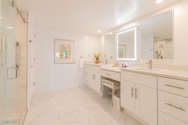 bathroom with vanity and a shower with shower door