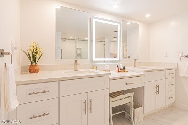 bathroom with vanity and a shower with shower door