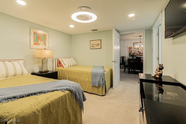 bedroom with light colored carpet and a notable chandelier