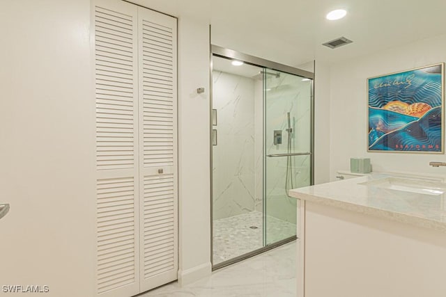 bathroom with vanity and a shower with door