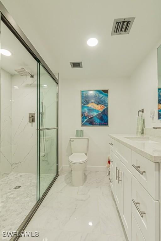 bathroom featuring vanity, toilet, and a tile shower