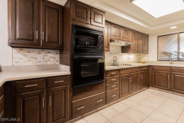 kitchen featuring light tile patterned flooring, sink, dark brown cabinets, and black appliances