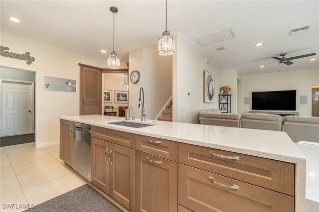 kitchen with ceiling fan, sink, stainless steel dishwasher, pendant lighting, and light tile patterned floors