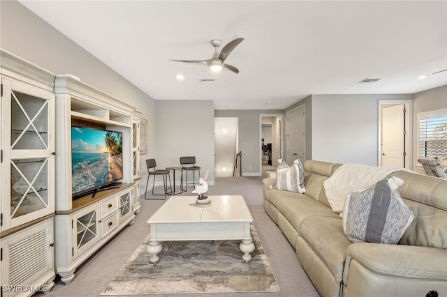 living room with carpet flooring and ceiling fan