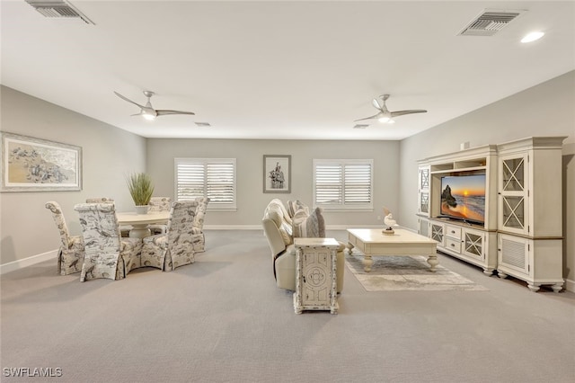 living room with ceiling fan, plenty of natural light, and light carpet