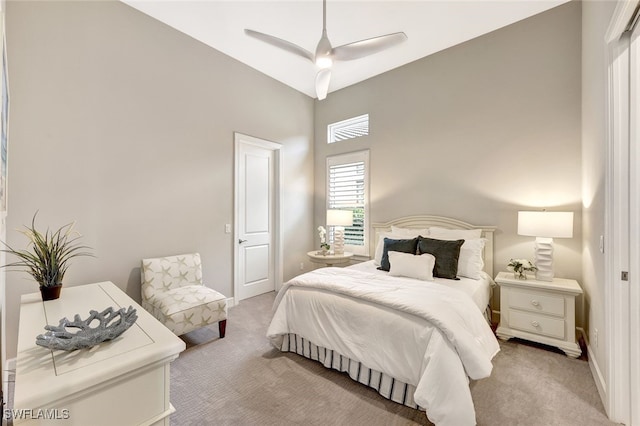 carpeted bedroom with ceiling fan and vaulted ceiling