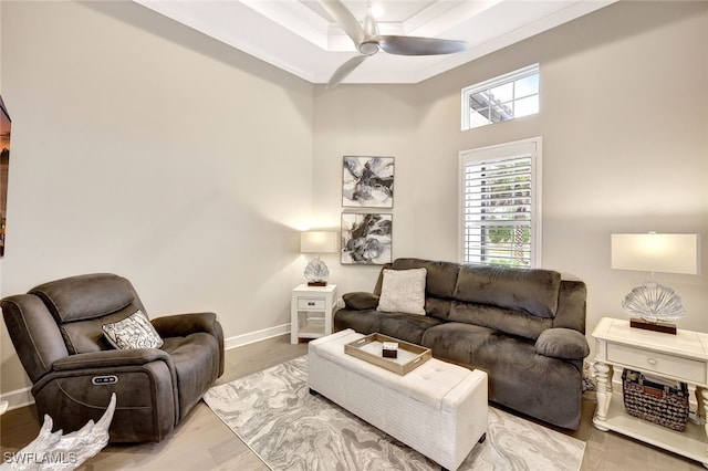 living room with ceiling fan, light wood-type flooring, and ornamental molding