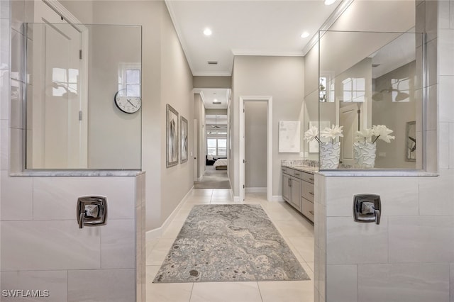 bathroom featuring tile patterned flooring, vanity, ornamental molding, and walk in shower