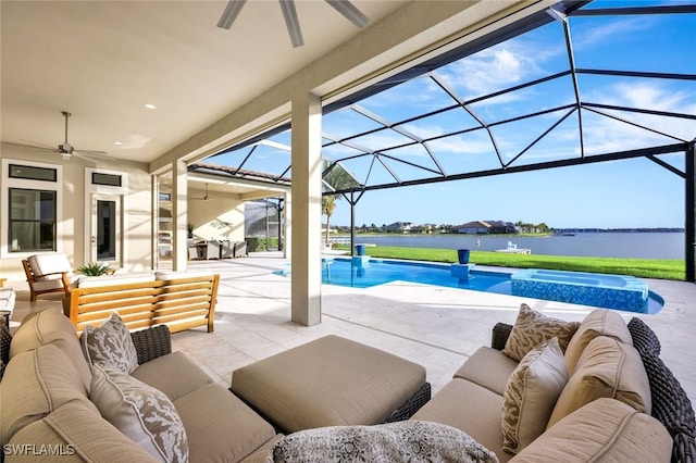 view of patio featuring outdoor lounge area, ceiling fan, a water view, and a lanai