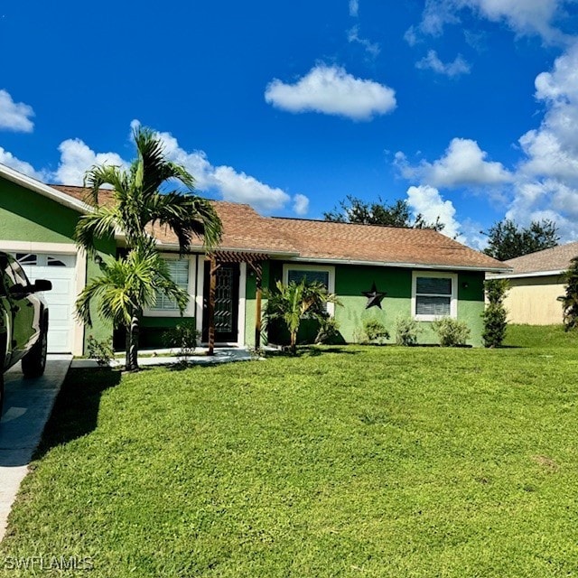 ranch-style house featuring a front lawn and a garage