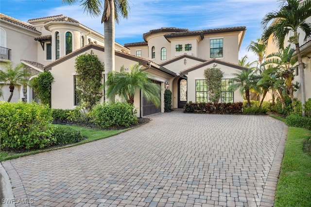 mediterranean / spanish house featuring a garage