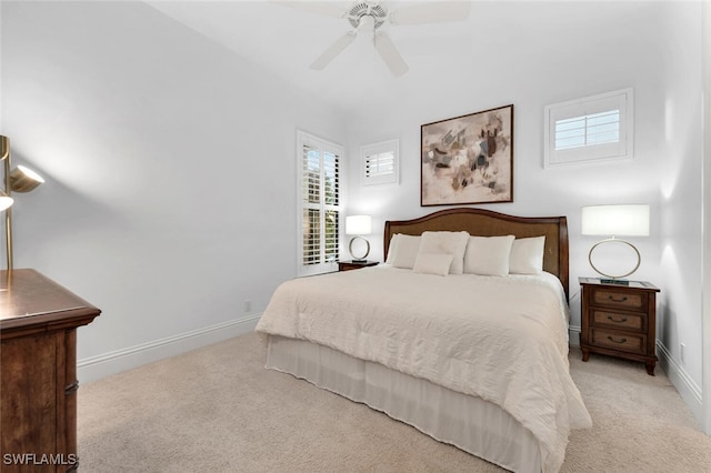 bedroom with ceiling fan and light carpet