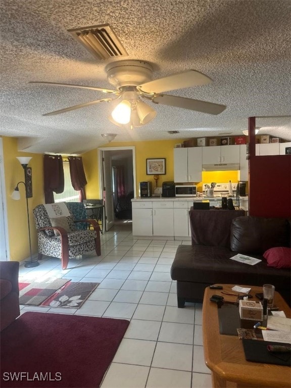 tiled living room with a textured ceiling and ceiling fan