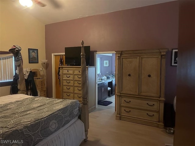 bedroom featuring connected bathroom, ceiling fan, and light hardwood / wood-style flooring