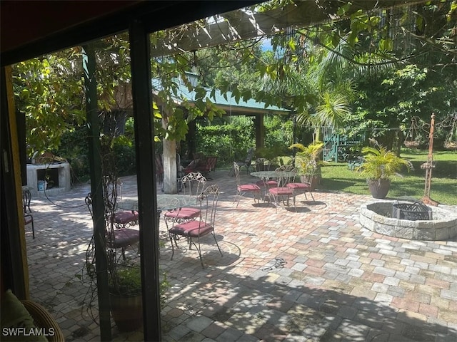 view of patio / terrace featuring an outdoor fire pit