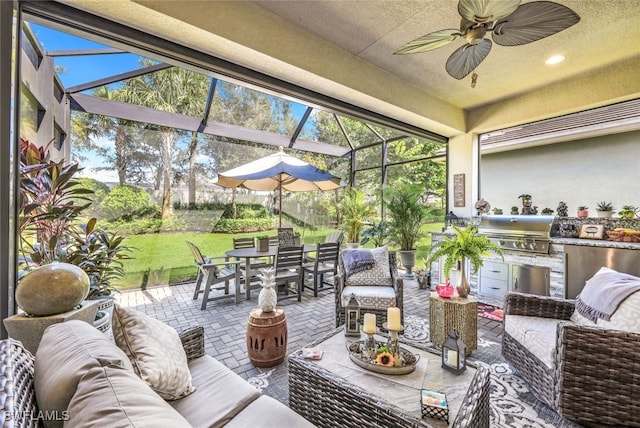 view of patio with a grill, a lanai, an outdoor hangout area, and exterior kitchen