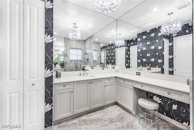 bathroom featuring vanity, an enclosed shower, and an inviting chandelier