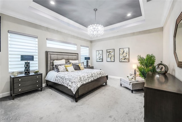 carpeted bedroom featuring crown molding, a tray ceiling, and a chandelier