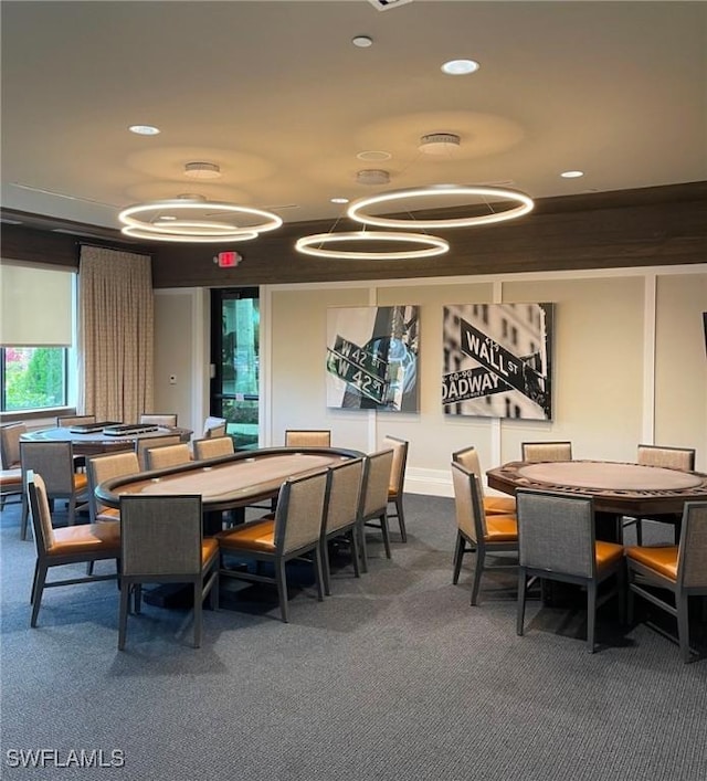 dining space featuring dark colored carpet