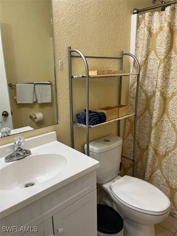 bathroom featuring tile patterned flooring, vanity, toilet, and a shower with curtain