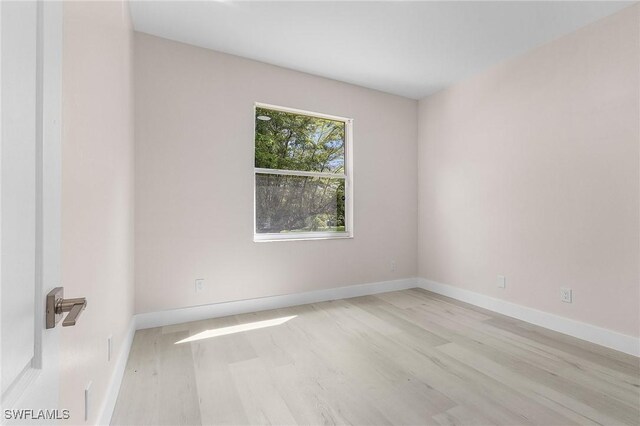 unfurnished room with light wood-type flooring